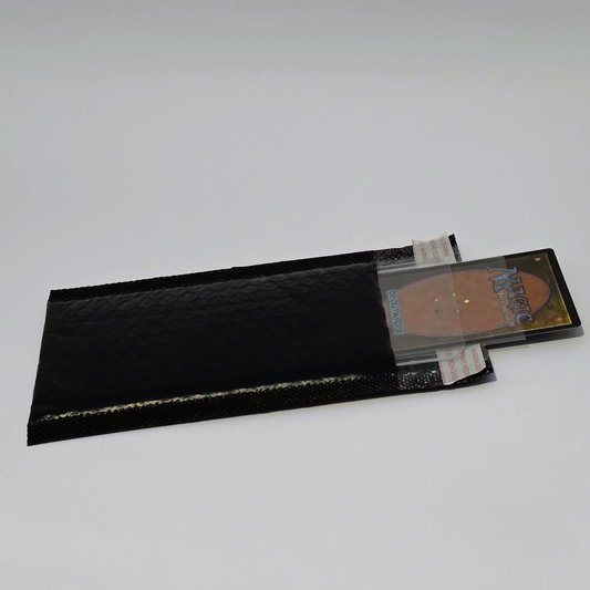 Trading card protected in a semi-rigid sleeve and packed inside a padded bubble mailer for mailing